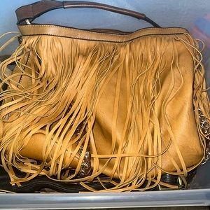 Leather fringed bag with gold linked decorative chain.